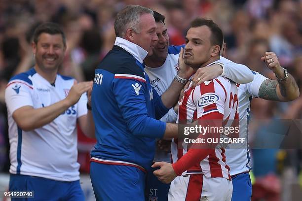 Stoke City's Swiss forward Xherdan Shaqiri celebrates scoring the opening goal with Stoke City's Scottish manager Paul Lambert during the English...