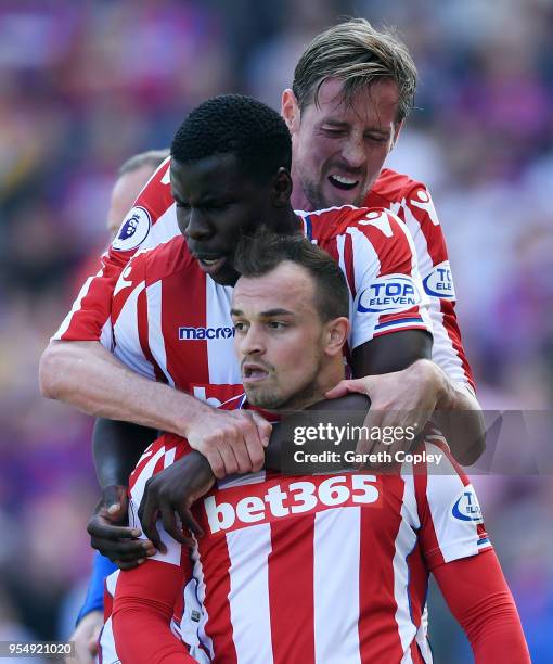 Xherdan Shaqiri of Stoke City celebrates scoring his side's first goal with team mates Kurt Zouma and Peter Crouch during the Premier League match...