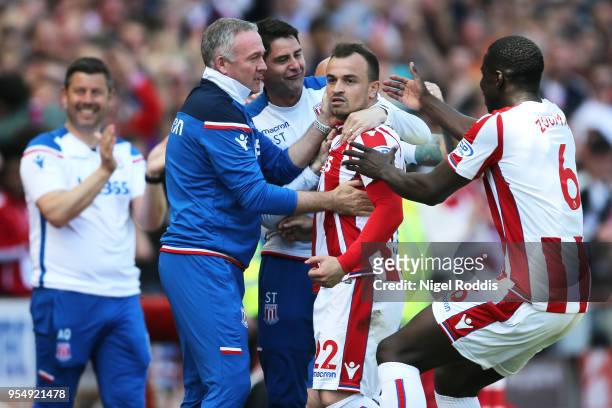 Xherdan Shaqiri of Stoke City celebrates with Paul Lambert, Manager of Stoke City and Kurt Zouma of Stoke City after scoring his sides first goal...