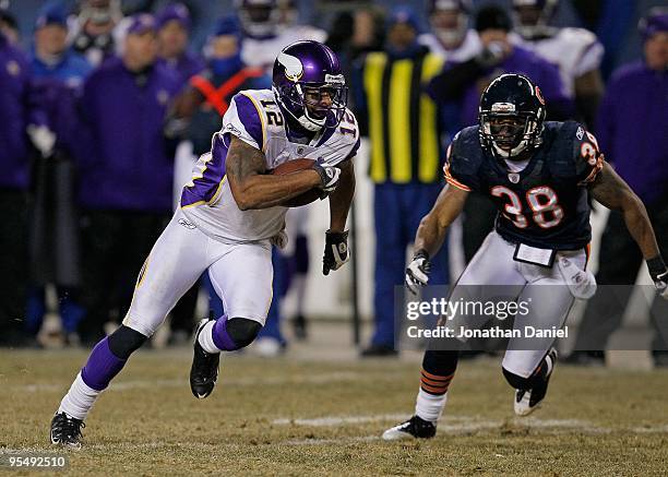 Percy Harvin of the Minnesota Vikings is chased by Danieal Manning of the Chicago Bears at Soldier Field on December 28, 2009 in Chicago, Illinois....