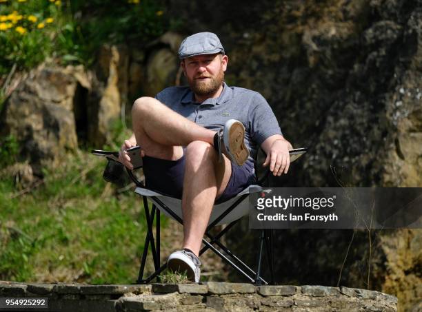 Spectator sits on the iconic Sutton Bank as he waits for the third stage of the Tour de Yorkshire cycling race on May 5, 2018 in Thirsk, United...