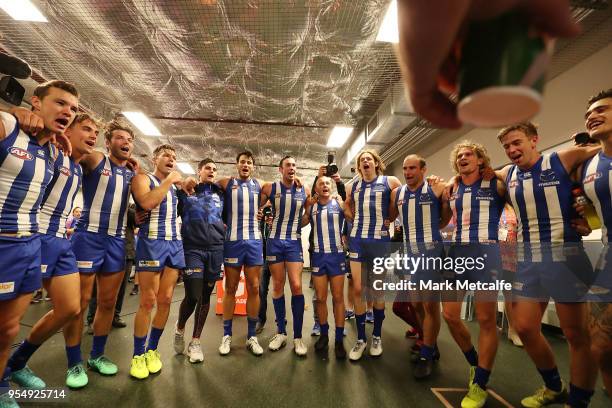 Kangaroos players celebrate victory by singing the team song after the round seven AFL match between the Sydney Swans and the North Melbourne...