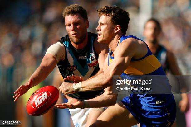 Jack Redden of the Eagles handballs against Brad Ebert of the Power during the round seven AFL match between the West Coast Eagles and the Port...