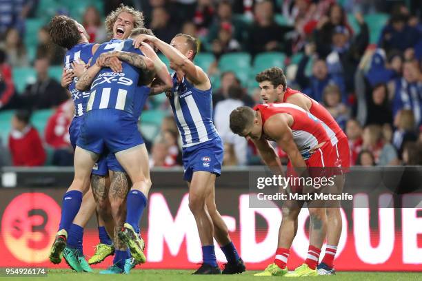 Kangaroos players celebrate victory in the round seven AFL match between the Sydney Swans and the North Melbourne Kangaroos at Sydney Cricket Ground...