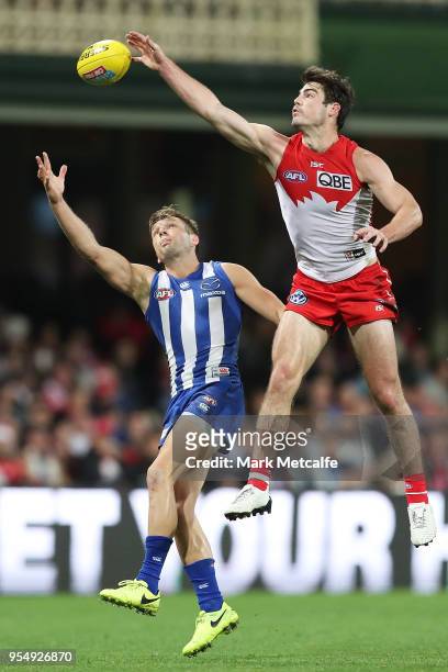 George Hewett of the Swans punches the ball ahead of Ben Jacobs of the Kangaroos during the round seven AFL match between the Sydney Swans and the...