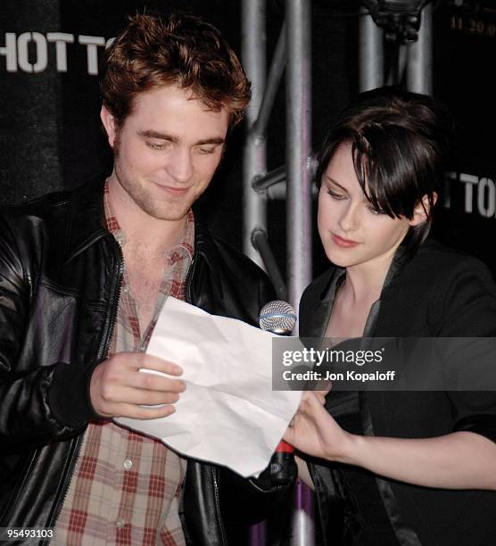 Actor Robert Pattinson and actress Kristen Stewart speak at "The Twilight Saga: New Moon" - Cast Tour at Hot Topic on November 6, 2009 in Hollywood,...