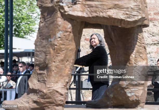 The Chinese artist Wu Weishan speaks next in to his sculpture of German philosopher and revolutionary Karl Marx during its inauguration at the 200th...