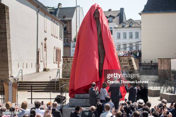 The sculpture of German philosopher and revolutionary Karl Marx is uncovered during its inauguration at the 200th anniversary of the birth of Karl...