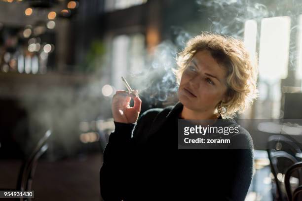 smoking in restaurant - cigarette stock pictures, royalty-free photos & images