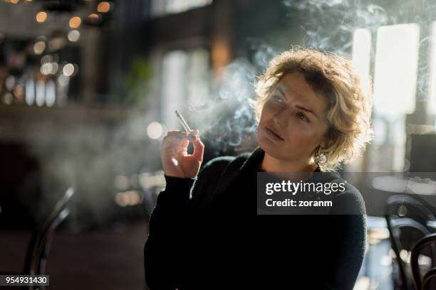 smoking in restaurant - lady cigarette stock pictures, royalty-free photos & images