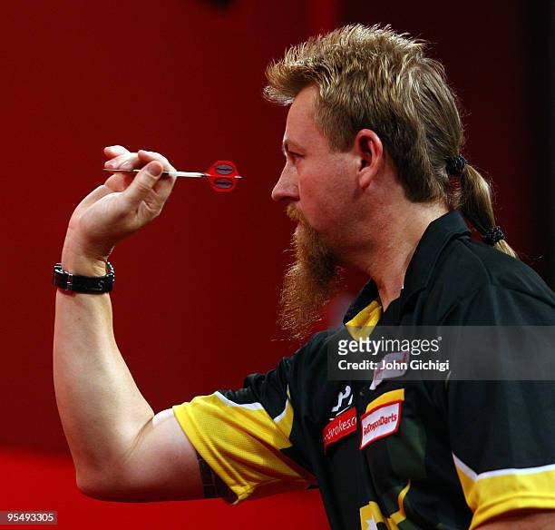 Simon Whitlock of Australia in action against Terry Jenkins of England during the 2010 Ladbrokes.com World Darts Championships at Alexandra Palace on...