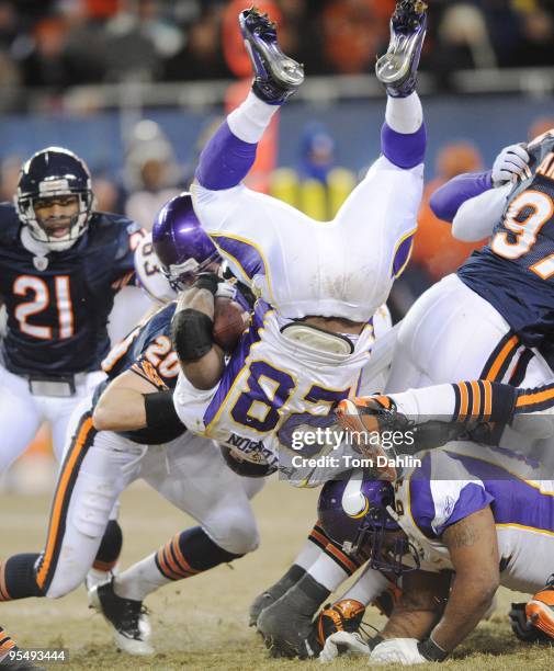 Adrian Peterson of the Minnesota Vikings is upended during an NFL Monday night game against the Chicago Bears at Soldier Field, December 28, 2009 in...