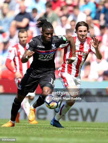 Wilfried Zaha of Crystal Palace and Joe Allen of Stoke City battle for the ball during the Premier League match between Stoke City and Crystal Palace...