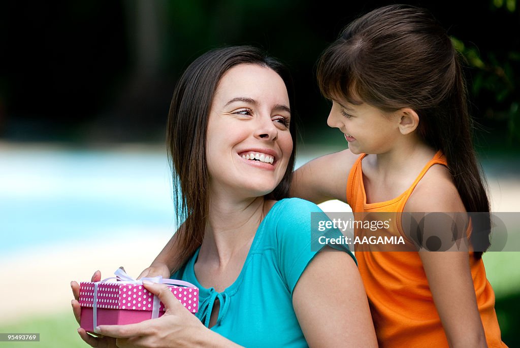 Daughter giving mother a present