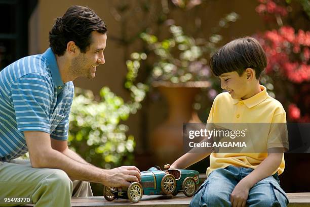 father and son with a toy car - ancine and car stock pictures, royalty-free photos & images