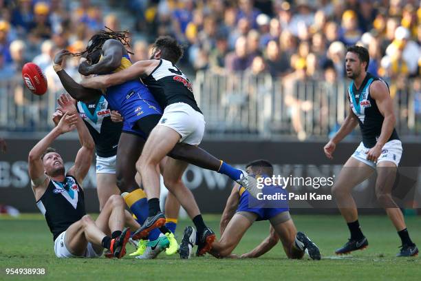 Nic Naitanui of the Eagles gets his handball away while being tackled by Justin Westhoff of the Power during the round seven AFL match between the...