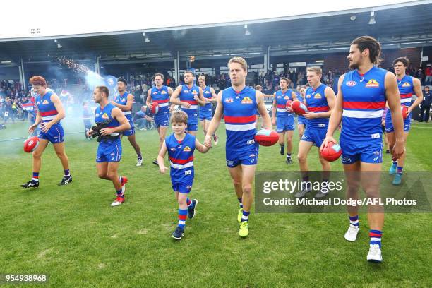 Lachie Hunter of the Bulldogs leads the team out during the round seven AFL match between the Western Bulldogs and the Gold Coast Suns at Mars...