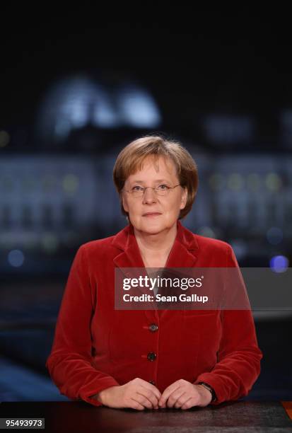 German Chancellor Angela Merkel poses moments after delivering her New Year's television address to the nation at the Chancellery on December 30,...