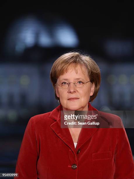 German Chancellor Angela Merkel poses moments after delivering her New Year's television address to the nation at the Chancellery on December 30,...