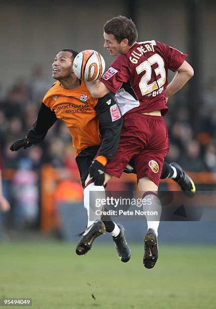 Peter Gilbert of Northampton Town challenges for the ball with Dean Sinclair of Barnet during the Coca Cola League Two Match between Barnet and...