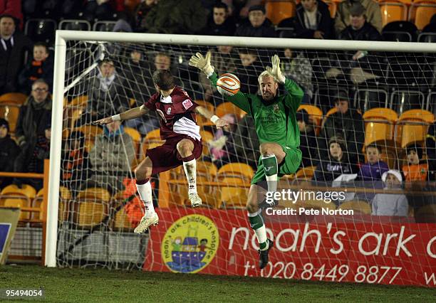 Jake Cole of Barnet attempts to collect the ball under pressure from Ryan Gilligan of Northampton Town during the Coca Cola League Two Match between...