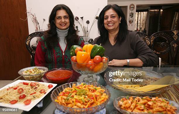 Sisters Shalini Lambah and Nandita Abbey of Herb Garden, which specialises in home-delivered low calorie pasta and salads, pose with some of their...