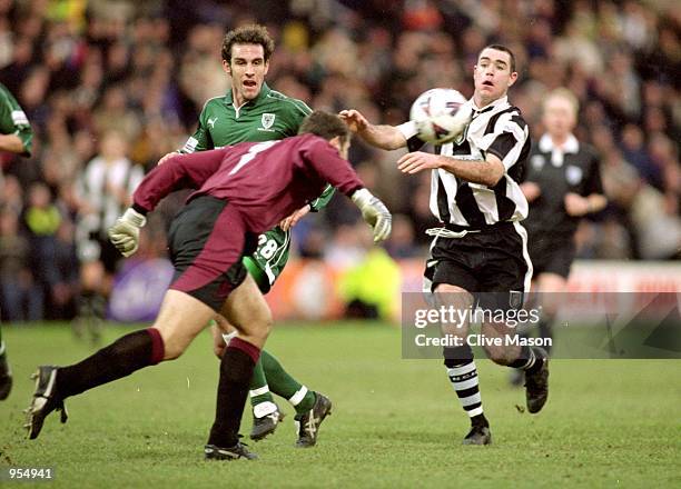 Kelvin Davies of Wimbledon clears from Andy Hughes of Notts County during the FA Cup Third Round Replay at Meadow Lane in Nottingham, England....