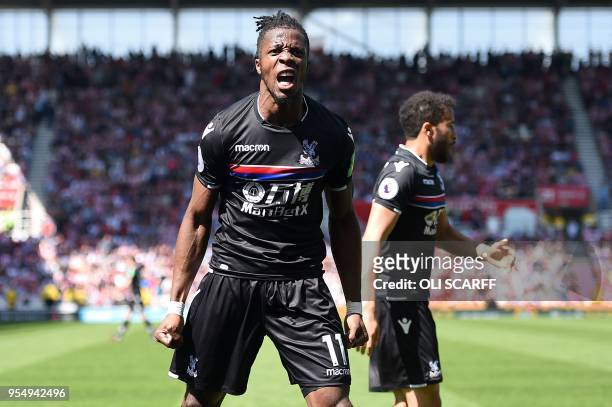 Crystal Palace's Ivorian striker Wilfried Zaha celebrates after scoring the equalising goal during the English Premier League football match between...