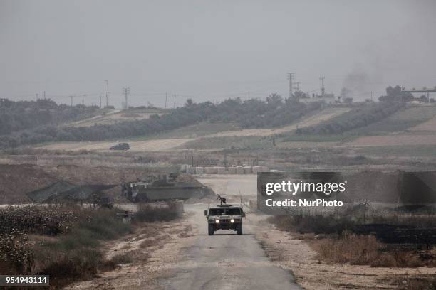 An Israeli military vehicle patrols the Gaza border on Friday, 4 May 2018, as Palestinians inside the Gaza Strip continue to protest adjacent to the...