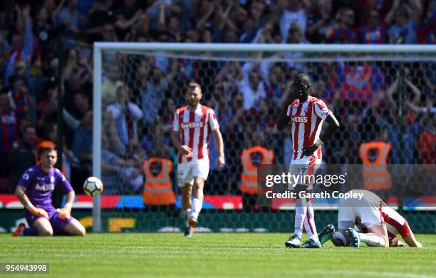 Badou Ndiaye of Stoke City and team mates look dejected following Patrick van Aanholt of Crystal Palace scoring his side's second goal during the...