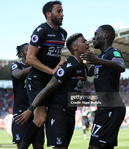 Patrick van Aanholt of Crystal Palcace celebrates scoring his side's second goal with team mates Andros Townsend and Christian Benteke during the...