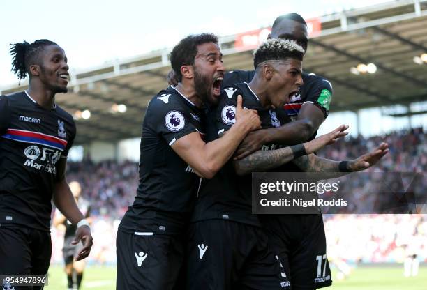 Patrick van Aanholt of Crystal Palcace celebrates scoring his side's second goal with team mates Andros Townsend and Christian Benteke during the...