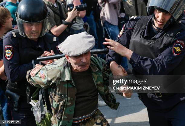 Russian police officers detain a participant of an unauthorized anti-Putin rally called by opposition leader Alexei Navalny on May 5, 2018 in Moscow,...