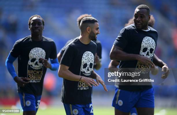 Riyad Mahrez of Leicester City and team mate Wes Morgan take part in the team's annual run during warm ups ahead of the Premier League match between...