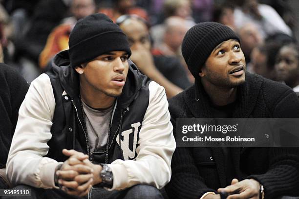 Recording artist Chris Brown and Usher attend the Cleveland Cavaliers vs. Atlanta Hawks game at Philips Arena on December 29, 2009 in Atlanta,...