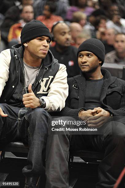 Recording artist Chris Brown and Usher attend the Cleveland Cavaliers vs. Atlanta Hawks game at Philips Arena on December 29, 2009 in Atlanta,...