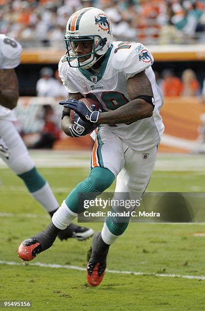 Ted Ginn, Jr. #19 of the Miami Dolphins carries the ball during a NFL game against the Houston Texans at Land Shark Stadium on December 27, 2009 in...