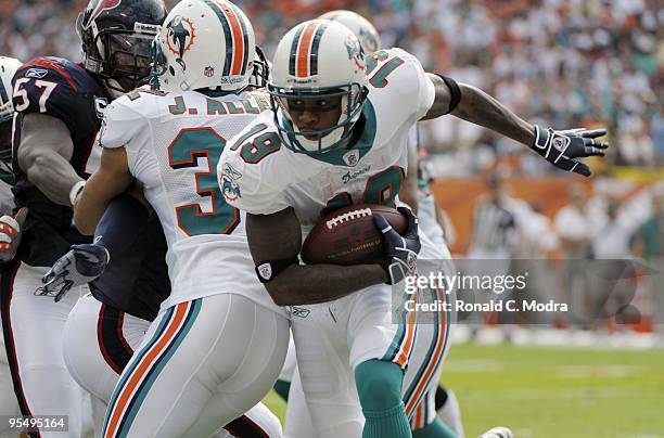 Ted Ginn, Jr. #19 of the Miami Dolphins carries the ball during a NFL game against the Houston Texans at Land Shark Stadium on December 27, 2009 in...