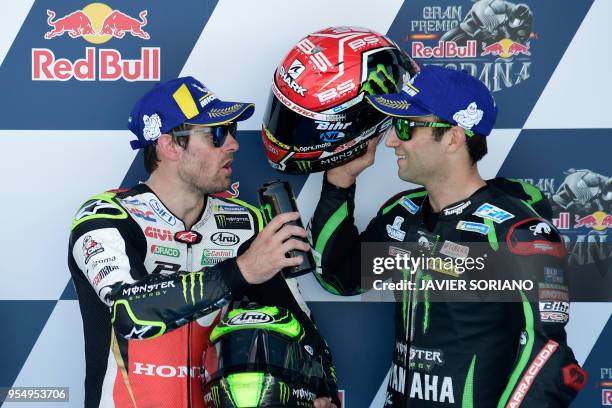 Monster Yamaha Tech 3's French rider Johann Zarco , third, speaks with LCR Honda's British rider Cal Crutchlow, first, after the MotoGP qualifying...