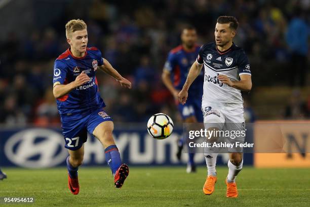 Riley McGree of the Jets contests the ball against Kosta Barbarouses of Melbourne Victory during the 2018 A-League Grand Final match between the...