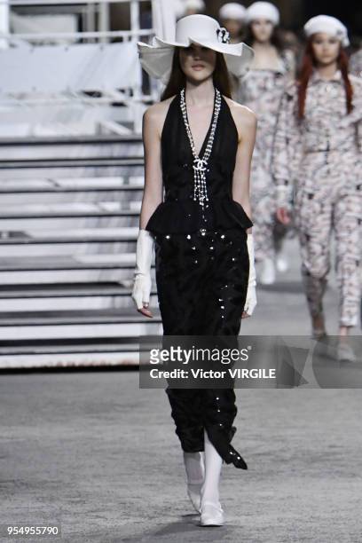 Model walks the runway during Chanel Cruise 2018/2019 Collection fashion show at Le Grand Palais on May 3, 2018 in Paris, France.