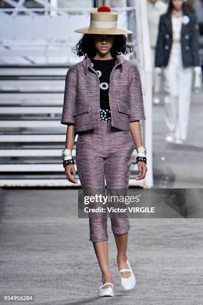 Model walks the runway during Chanel Cruise 2018/2019 Collection fashion show at Le Grand Palais on May 3, 2018 in Paris, France.