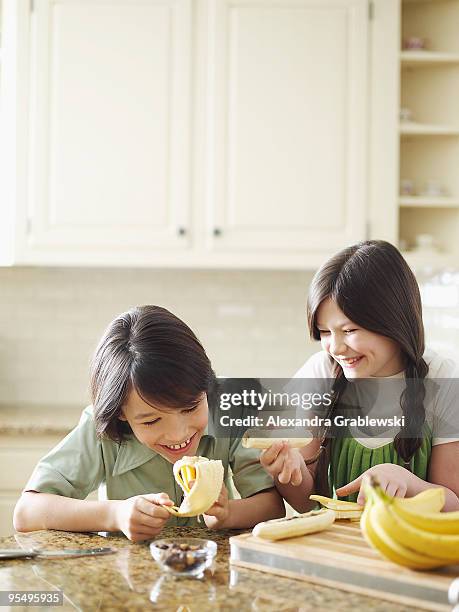 boy and girl making banana splits. - banana split stock pictures, royalty-free photos & images