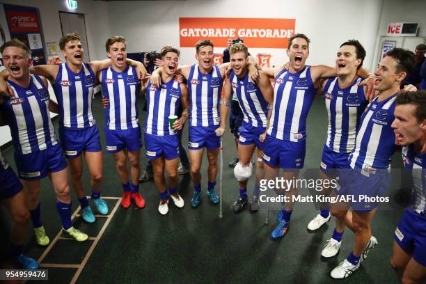The Kangaroos celebrate victory and sing the club song after the round seven AFL match between the Sydney Swans and the North Melbourne Kangaroos at...