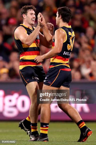 Mitch McGovern and Darcy Fogarty of the Crows celebrate a goal during the 2018 AFL round seven match between the Adelaide Crows and the Carlton Blues...