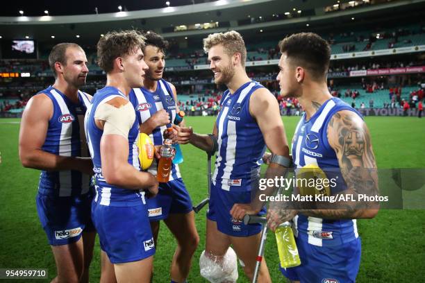 Ed Vickers-Willis of the Kangaroos celebrates victory with team mates after the round seven AFL match between the Sydney Swans and the North...