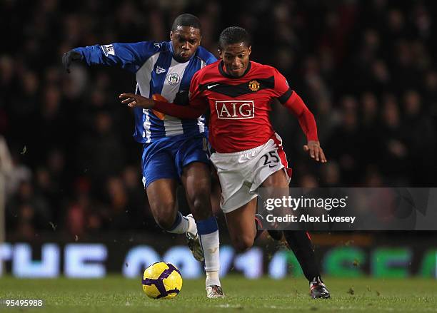 Charles N' Zogbia of Wigan Athletic battles for the ball with Antonio Valencia of Manchester United during the Barclays Premier League match between...