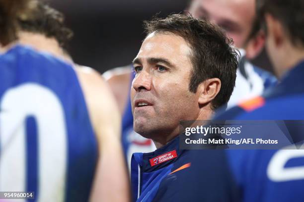 Kangaroos coach Brad Scott speaks to players at three quarter time during the round seven AFL match between the Sydney Swans and the North Melbourne...
