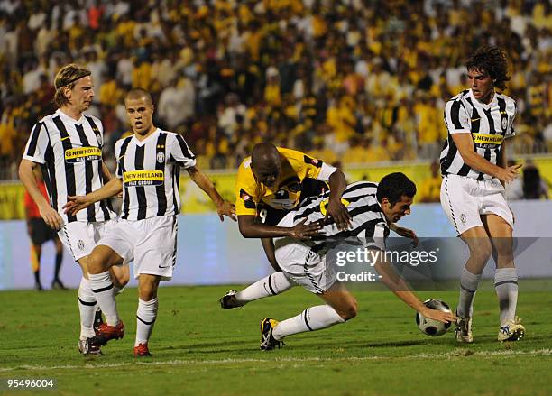 Al-Ittihad player Hamza Idriss battles Juventus oponents Christian Poulsen, Sebastian Giovinco, Cristian Molinaro and Ariaudo Lorenzo during their...