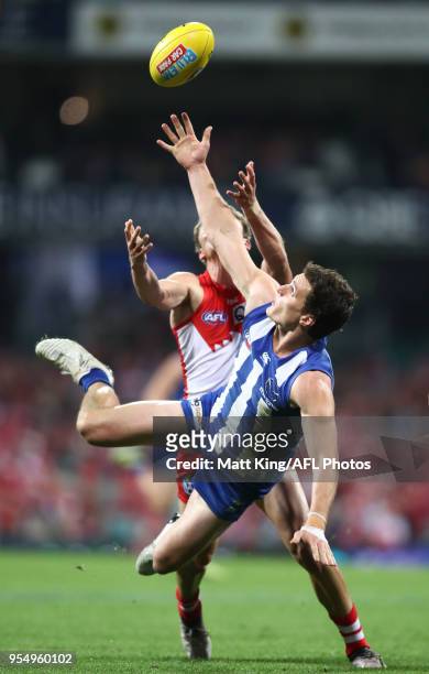 Scott D. Thompson of the Kangaroos is challenged by Will Hayward of the Swans during the round seven AFL match between the Sydney Swans and the North...